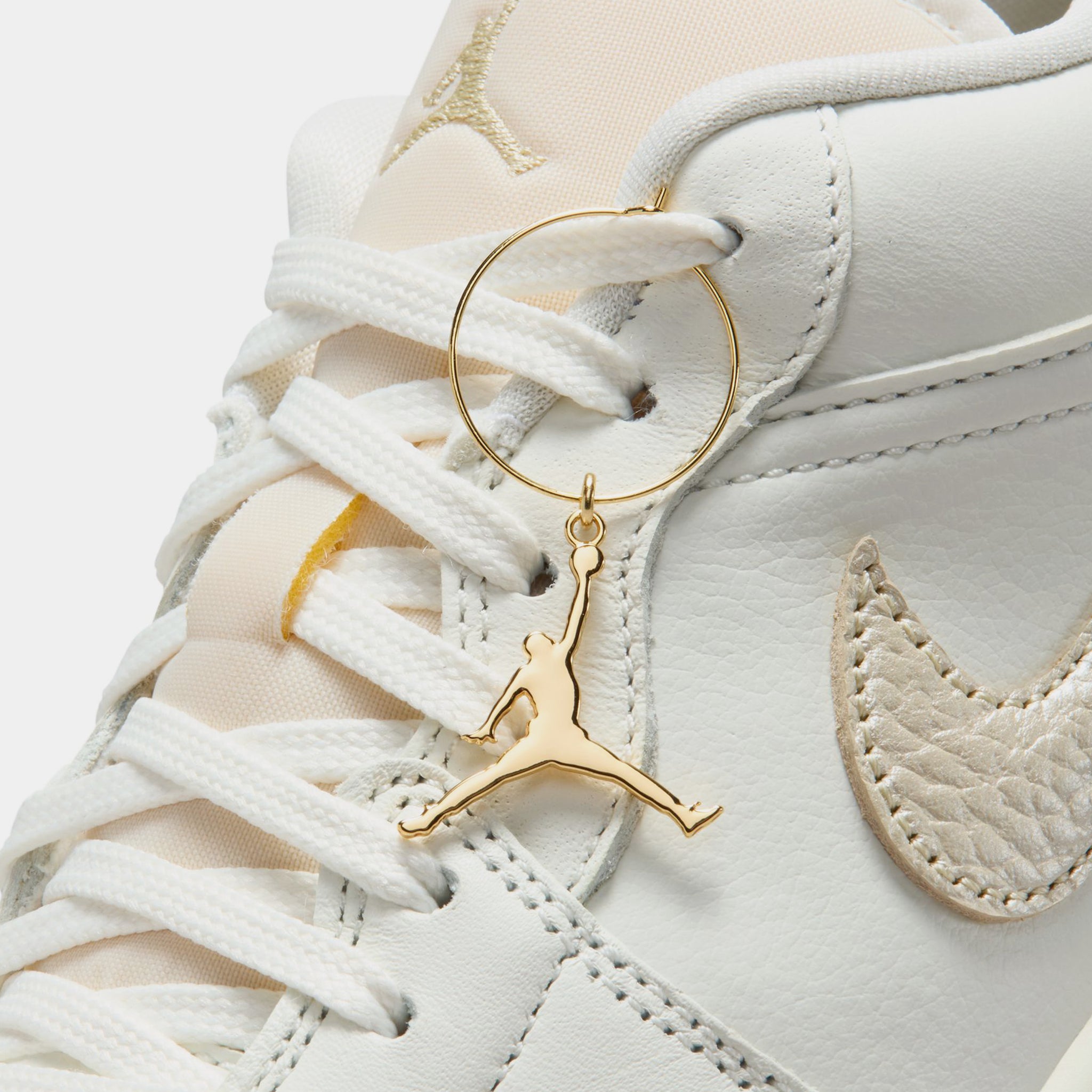gold and white jordan shoes