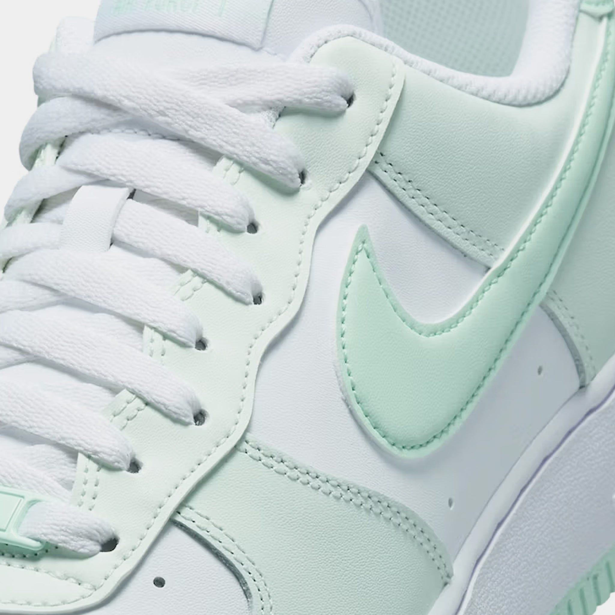 mint green and white nike trainers