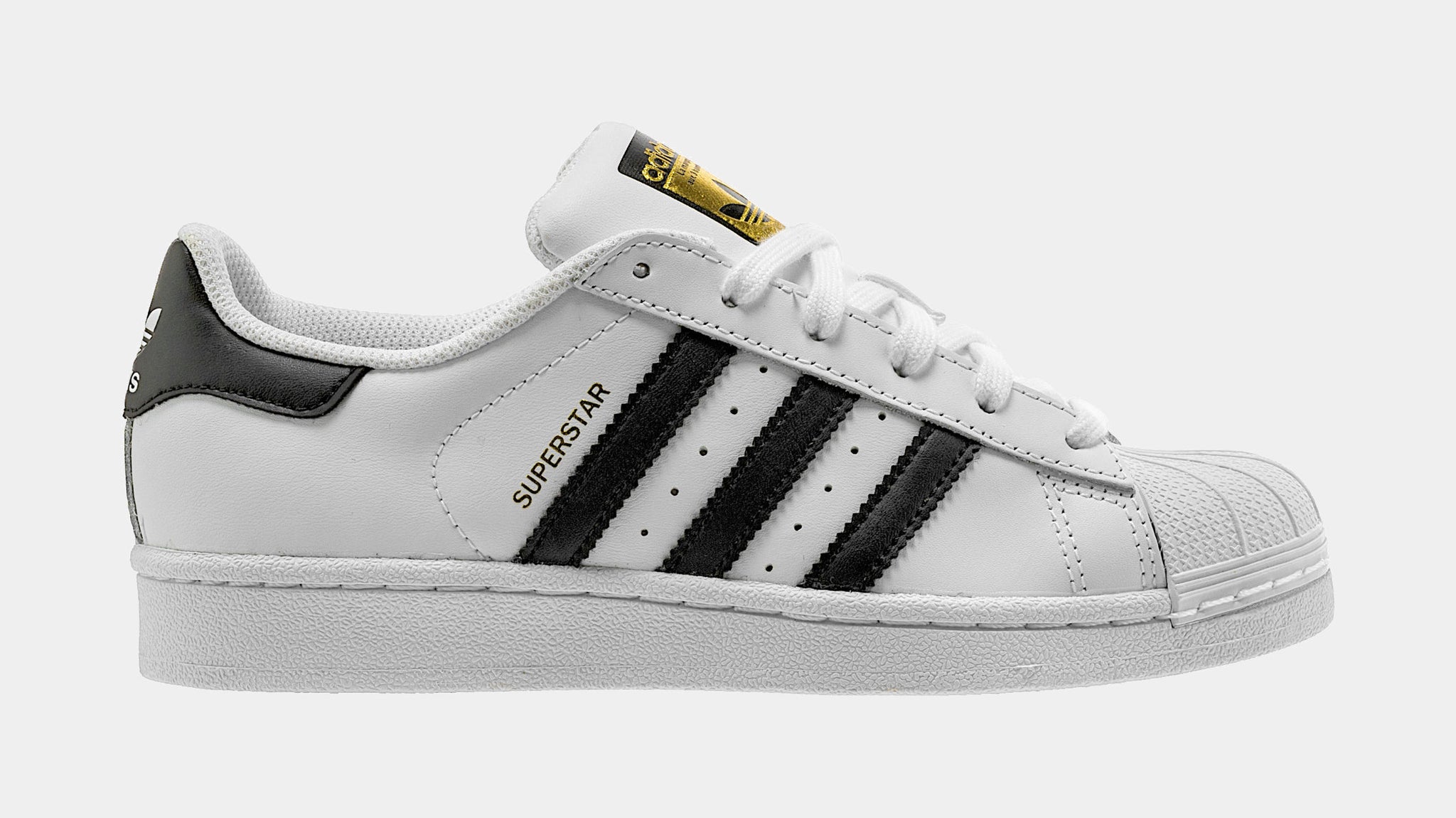 Old School shell toe Superstar Adidas tennis shoes.